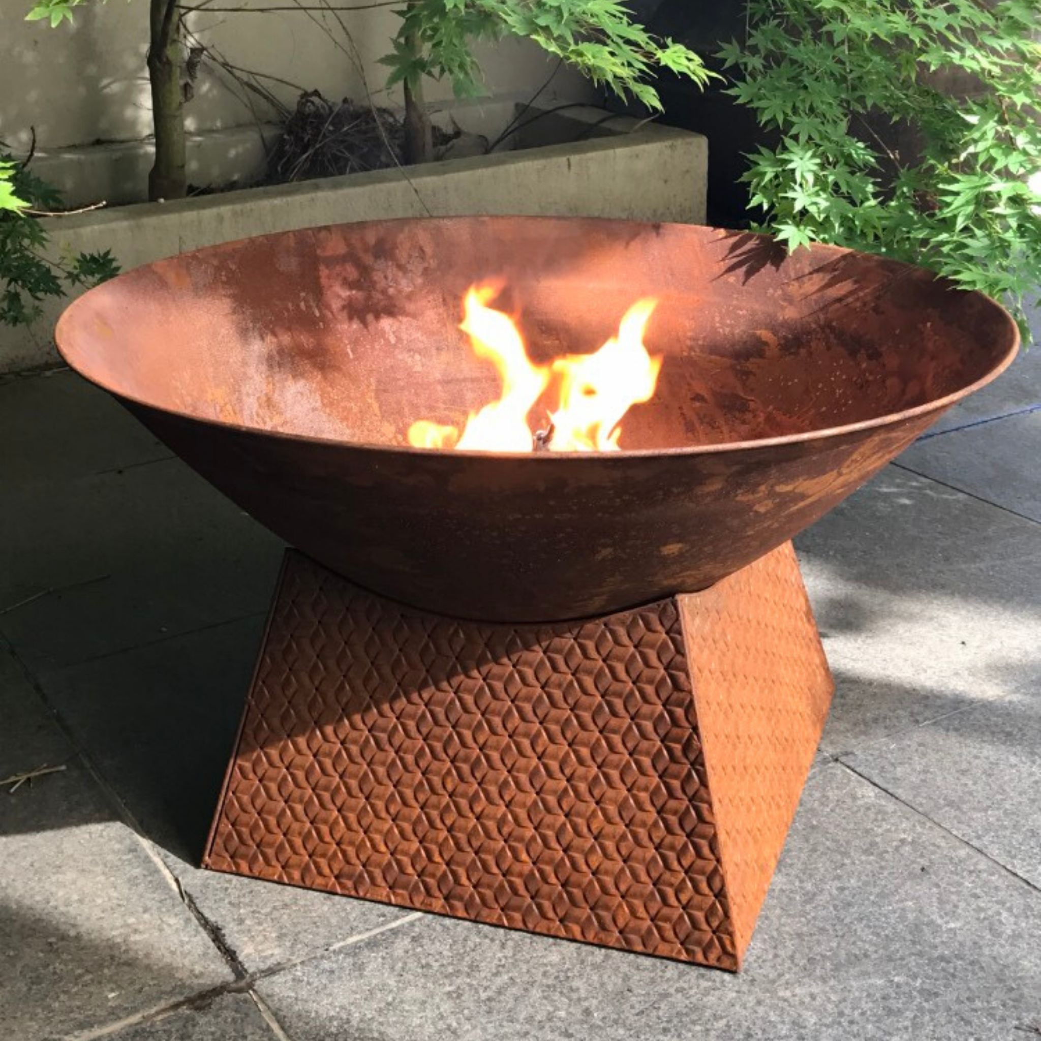 rusty metal fire bowl with weave base